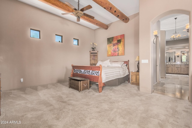 carpeted bedroom featuring multiple windows, ensuite bathroom, ceiling fan with notable chandelier, beam ceiling, and a towering ceiling