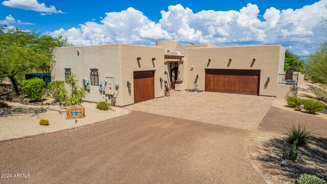 pueblo-style home featuring a garage