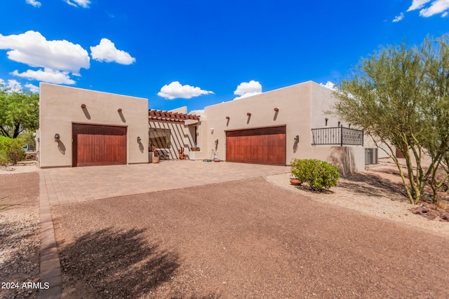 pueblo revival-style home with a garage