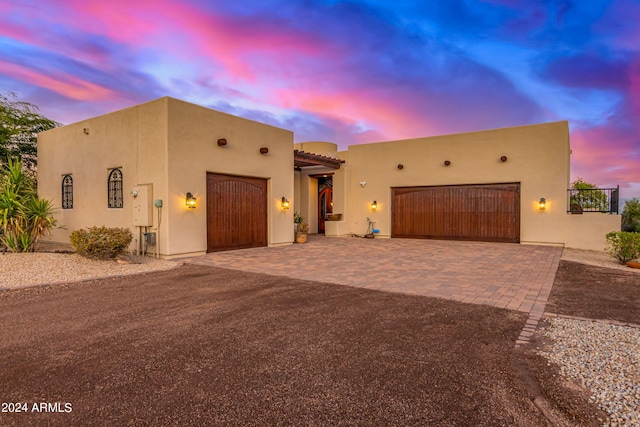 pueblo-style home with a garage