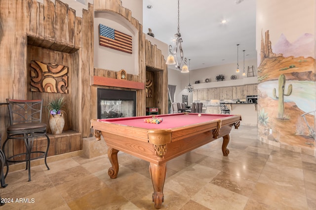 recreation room with pool table and a towering ceiling