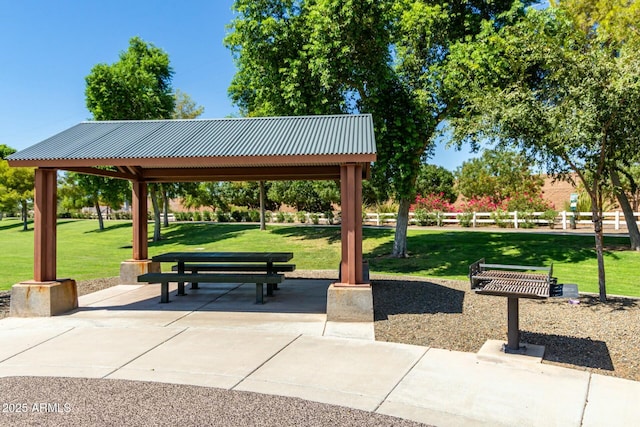 view of home's community with a lawn, fence, a gazebo, and a patio