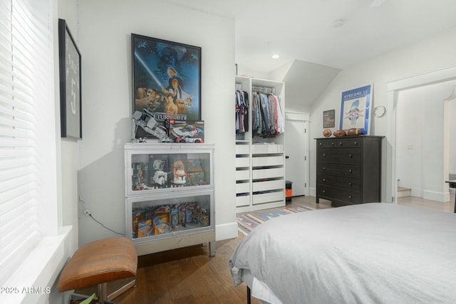 bedroom featuring lofted ceiling, a closet, wood finished floors, and recessed lighting