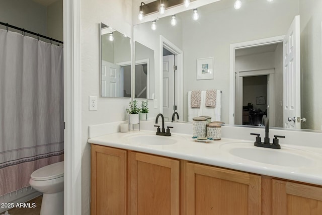 bathroom featuring double vanity, a sink, toilet, and a shower with curtain