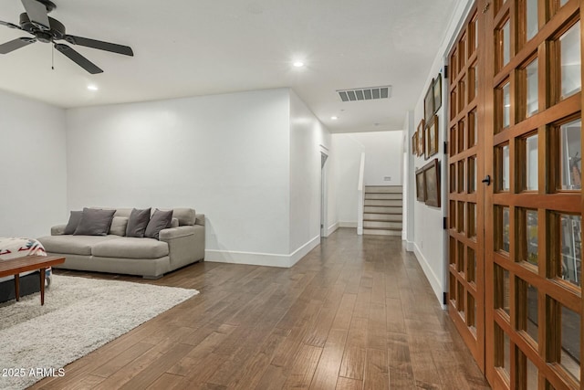 living area featuring dark wood-style floors, stairs, visible vents, and recessed lighting