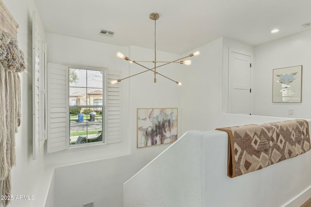 interior space featuring an inviting chandelier, visible vents, and recessed lighting