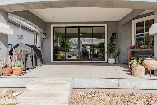 entrance to property with stucco siding