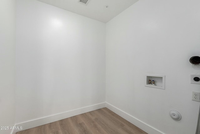 laundry room featuring gas dryer hookup, hookup for a washing machine, light wood-style flooring, hookup for an electric dryer, and laundry area