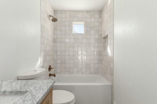 bathroom with tub / shower combination, vanity, and toilet