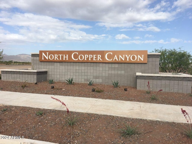 community sign with a mountain view