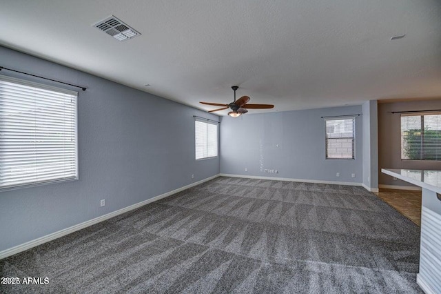 carpeted spare room with ceiling fan