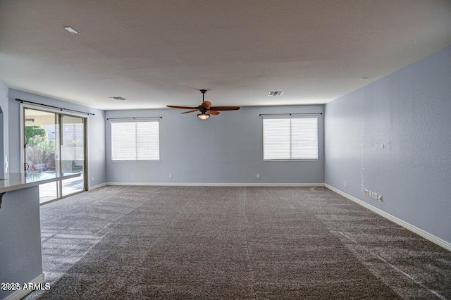 unfurnished room featuring ceiling fan and carpet flooring