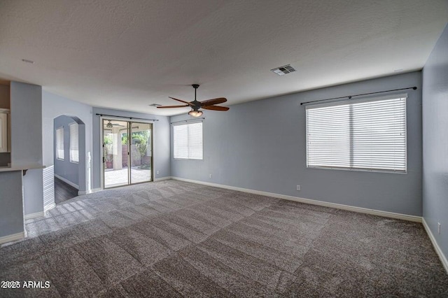 spare room featuring ceiling fan and carpet