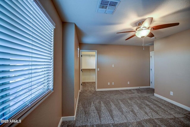 carpeted empty room featuring ceiling fan