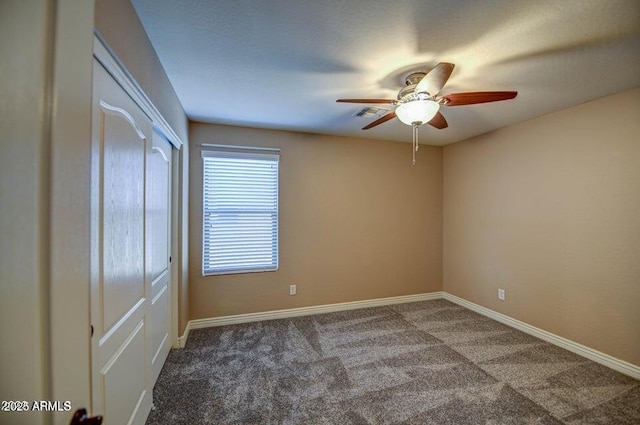 carpeted empty room featuring ceiling fan