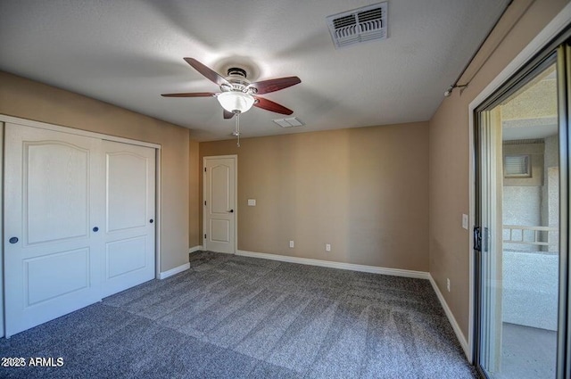 unfurnished bedroom with ceiling fan, a closet, and carpet floors