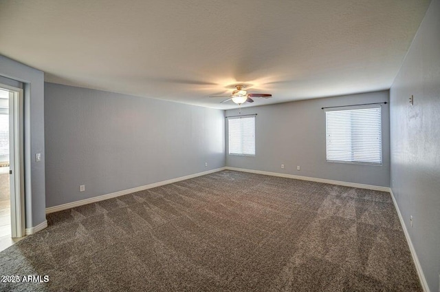 spare room with carpet floors and ceiling fan