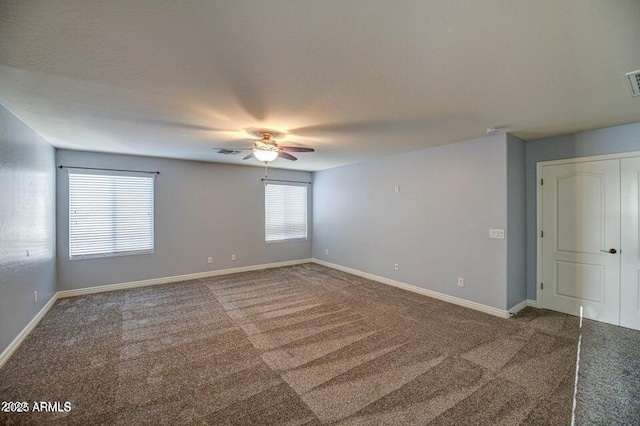 empty room with ceiling fan and carpet