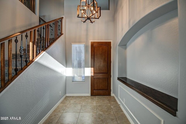 foyer with light tile patterned floors and a chandelier