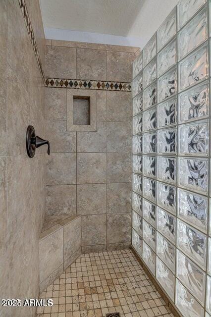 bathroom with tiled shower