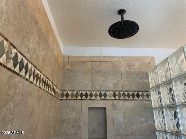 interior details with a tile shower