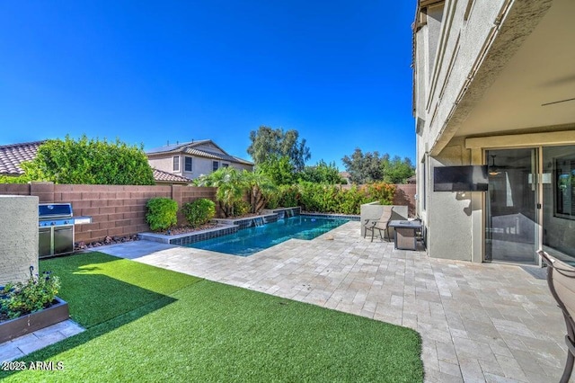 view of swimming pool with a lawn and a patio