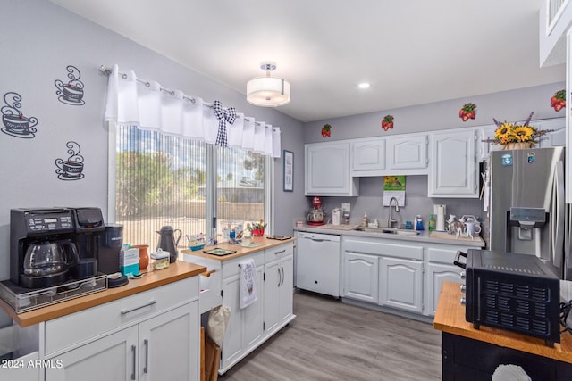 kitchen with white cabinetry, dishwasher, light hardwood / wood-style flooring, sink, and stainless steel fridge with ice dispenser