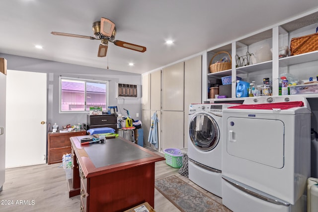 clothes washing area with washing machine and dryer, an AC wall unit, ceiling fan, and light hardwood / wood-style flooring