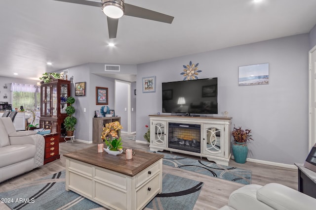 living room with ceiling fan and light wood-type flooring