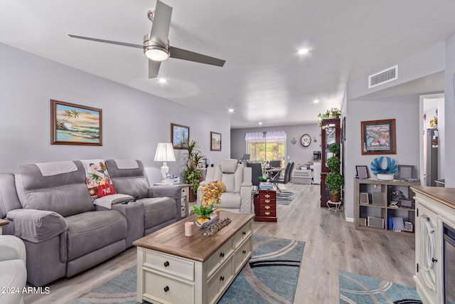 living room featuring ceiling fan and light wood-type flooring