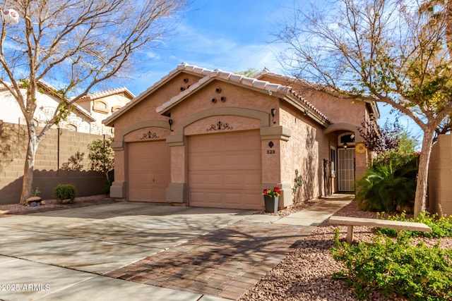 mediterranean / spanish house with a garage