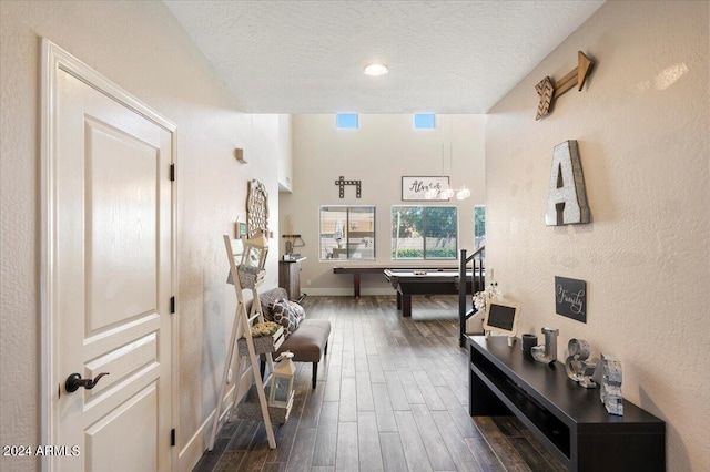 corridor featuring a textured ceiling and dark wood-type flooring