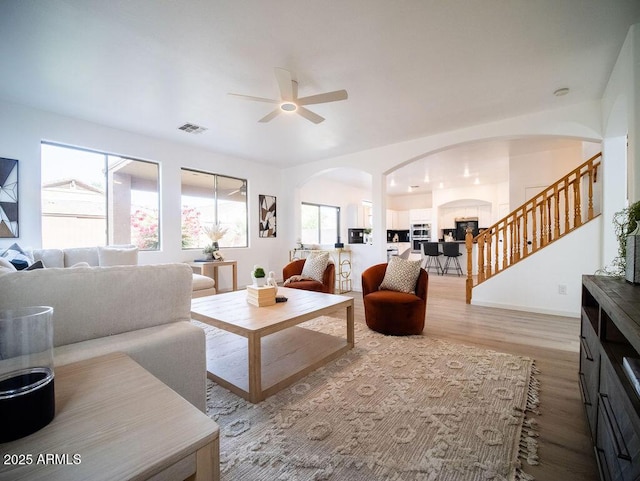 living room featuring light hardwood / wood-style floors and ceiling fan