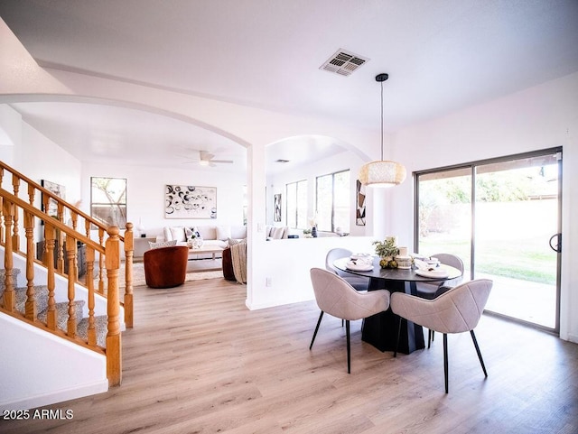 dining space featuring light wood-type flooring and ceiling fan