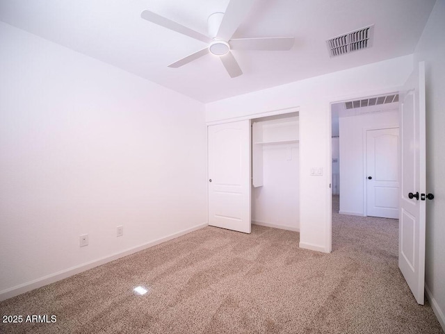 unfurnished bedroom with ceiling fan, a closet, and carpet floors