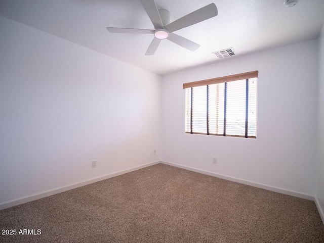 spare room featuring ceiling fan and carpet floors