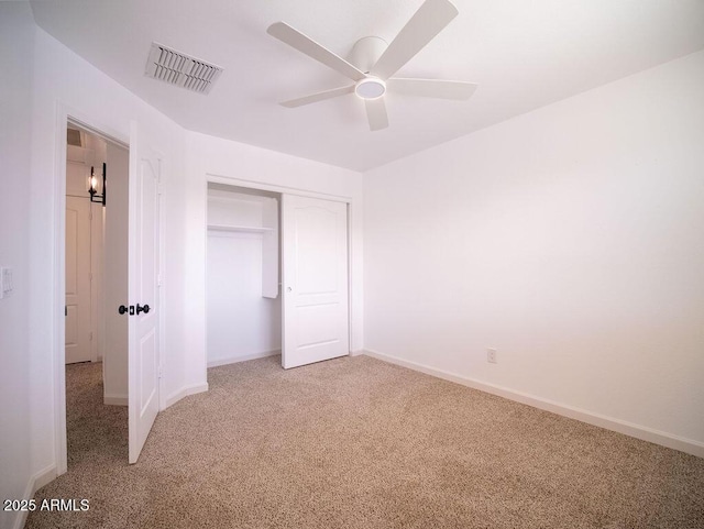 unfurnished bedroom with carpet floors, a closet, and ceiling fan