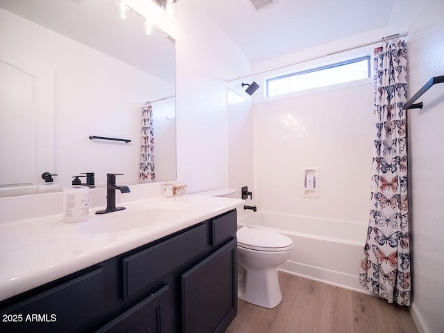 full bathroom with toilet, hardwood / wood-style floors, vanity, and shower / tub combo with curtain