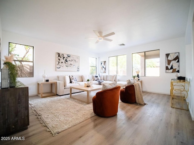 living room with hardwood / wood-style floors, plenty of natural light, and ceiling fan