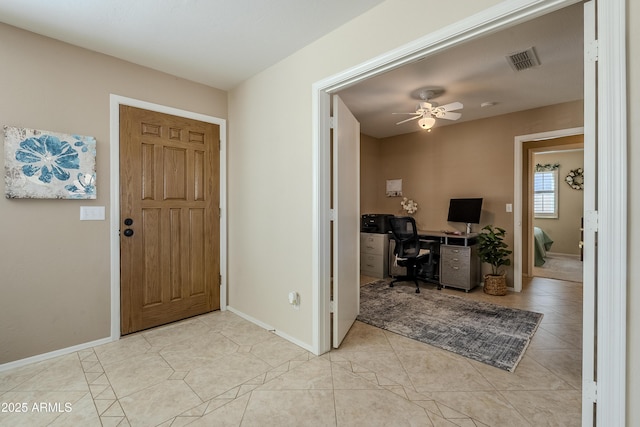 foyer entrance with ceiling fan and light tile patterned floors