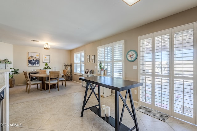 dining space featuring light tile patterned floors