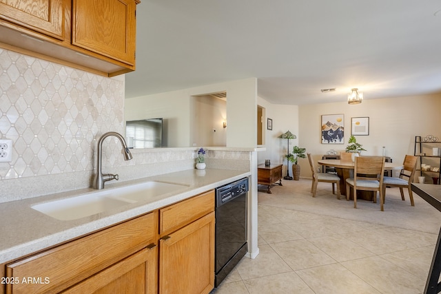 kitchen featuring dishwasher, sink, and light tile patterned floors