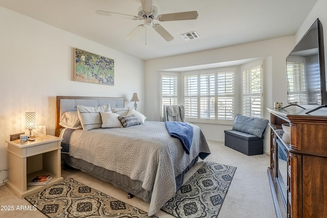 bedroom with ceiling fan and light carpet