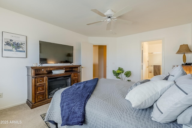 bedroom with ensuite bath, ceiling fan, and light colored carpet