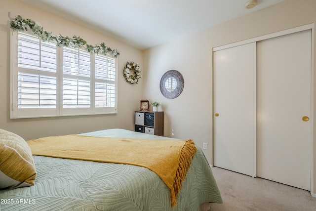 carpeted bedroom with a closet