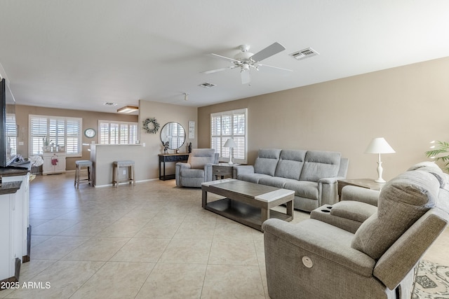 living room featuring light tile patterned floors and ceiling fan