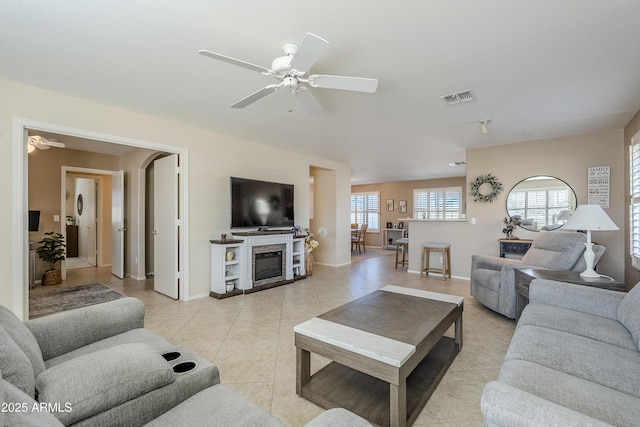 living room with ceiling fan and light tile patterned flooring