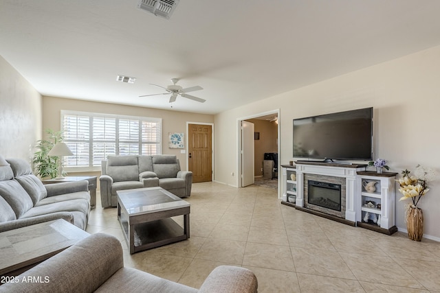 living room with ceiling fan and light tile patterned flooring