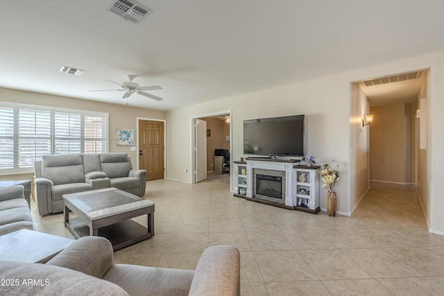 living room featuring ceiling fan and light tile patterned flooring