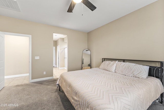 25969 W Tina Ln, Buckeye, AZ 85396 - bedroom with light carpet, light tile patterned flooring, and ceiling fan
